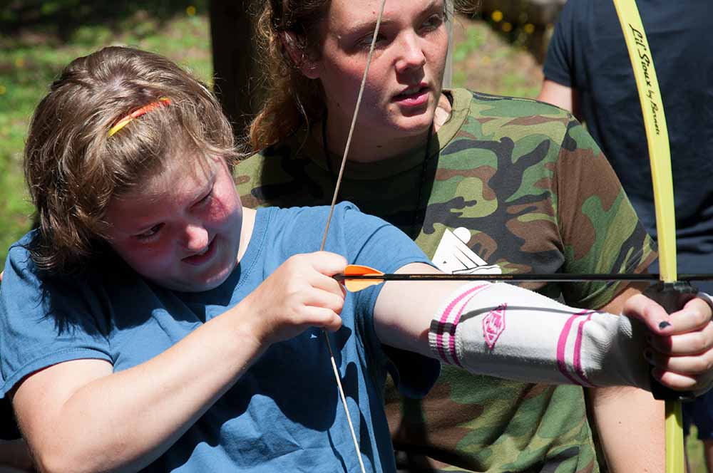 Girl shooting a bow and arrow