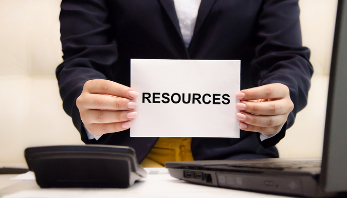 Hands holding sign that reads Resources