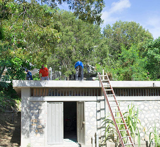 Filter building with people repairing roof