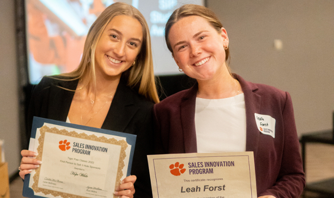 students holding awards