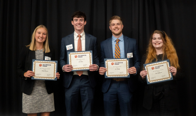 students holding awards