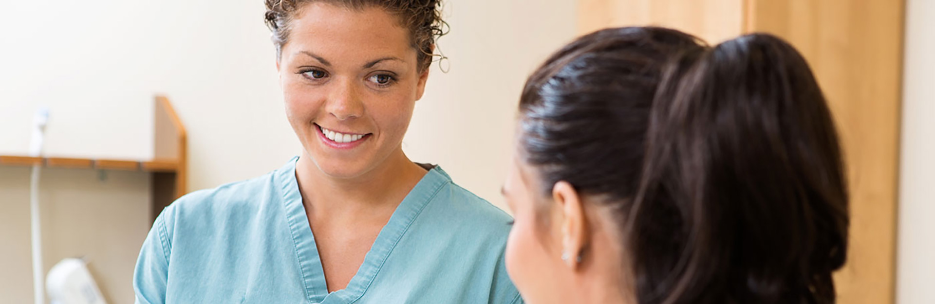 Female nurse talking to female