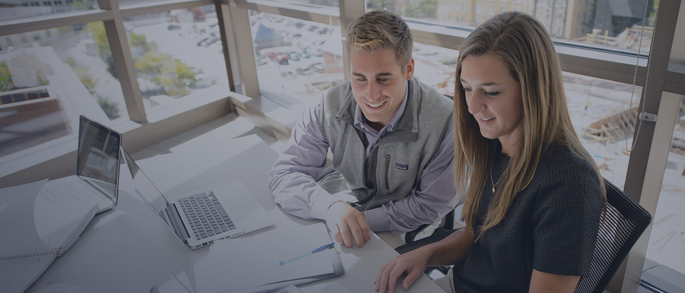 Man and woman working on laptop