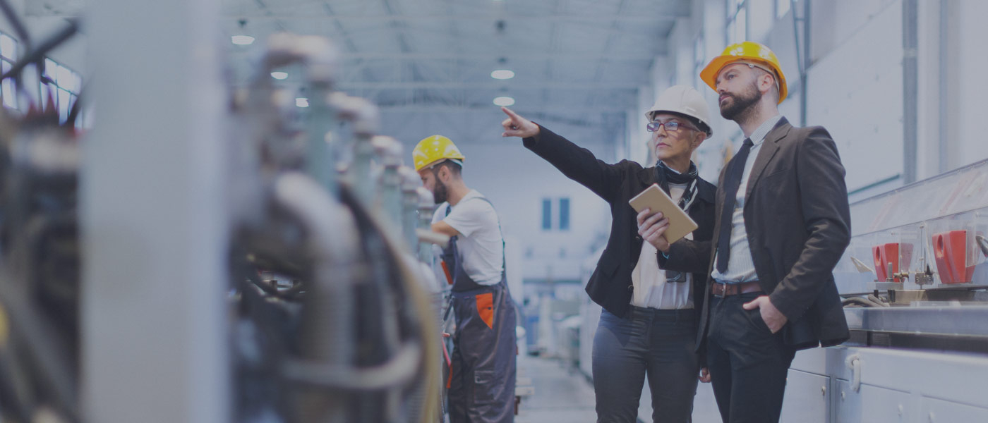 Men in hard hats talking in factory