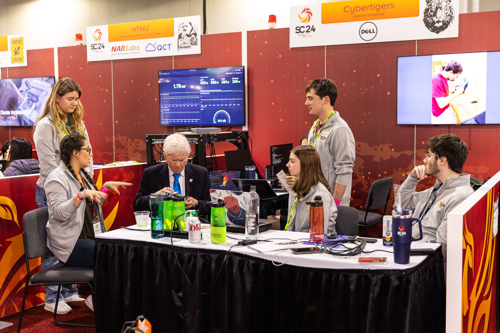Clemson Cybertigers talk to a judge at the 2024 Student Cluster Competition at Super Computing. 