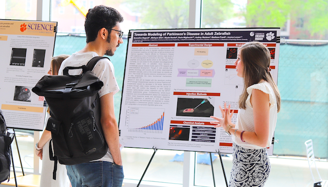 Student presenting a poster