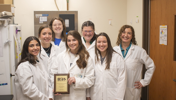 Carolina Elgaressta, Logan Thomason, Hannah Culler, Christian Wilhelm, Katie Kirkman, Izabella Zaraca and Dr. Celina Checura pose with their award plaque