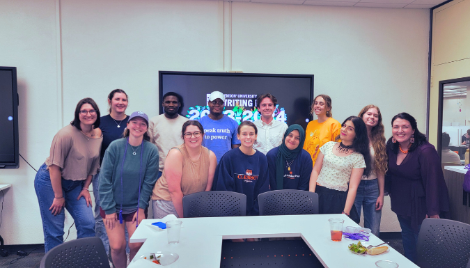 A group of Writing Lab staff members smile at the camera.