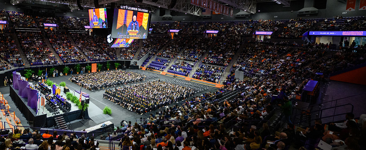 Littlejohn coliseum full of graduates in the center, with friends and family in the stands.