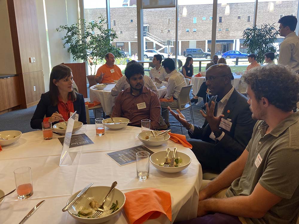 Members of the Honors College Advisory Board talking to students at a networking luncheon in 2023.