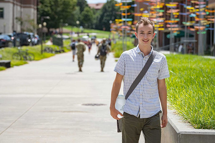 Student walking outside by the Honors Center