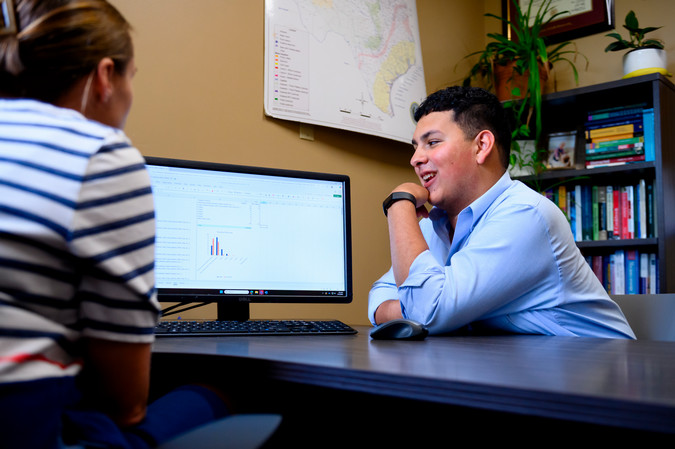 Ana Thayer reviewing research on the cmputer with Blake Arias