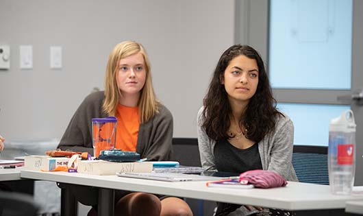 Two students sitting in a classroom