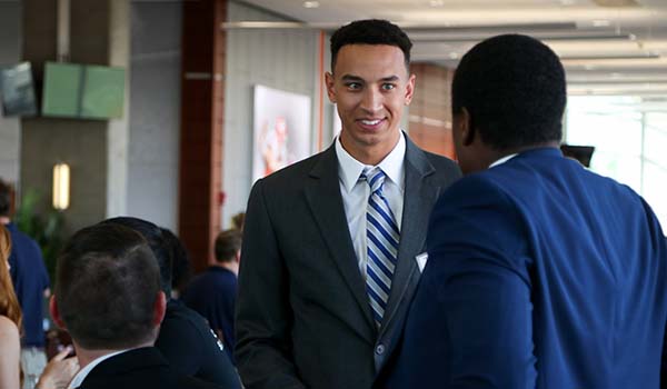 Two men talking at a networking event