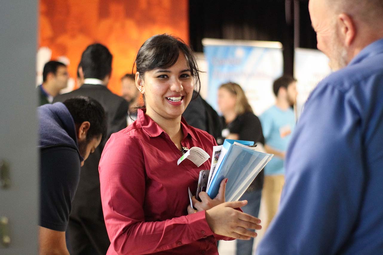 A student talking to an employer at a Clemson career fair.