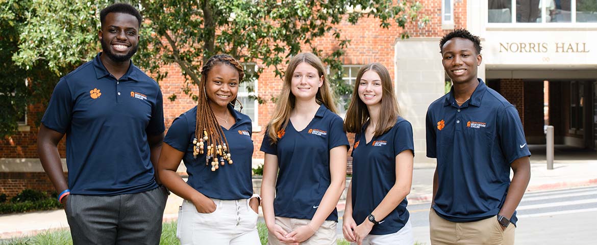 Students posing outside on Clemson campus. 