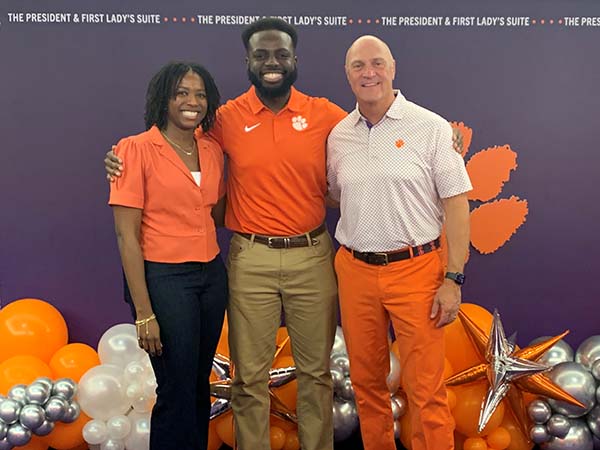 A Breakthrough Scholar posing between the Associate Director of the Program and President Clements.