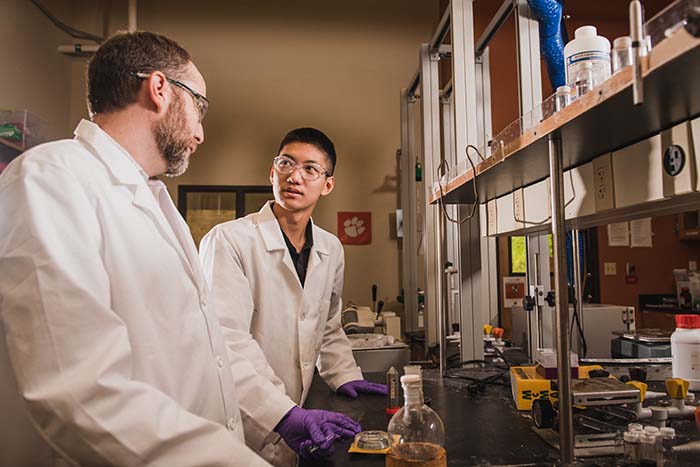 A student and teacher working in a lab