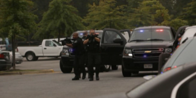 Active Shooter drill - police officers surveilling the area with their weapons.