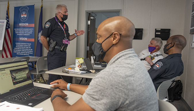 Officers have a meeting inside an office space.