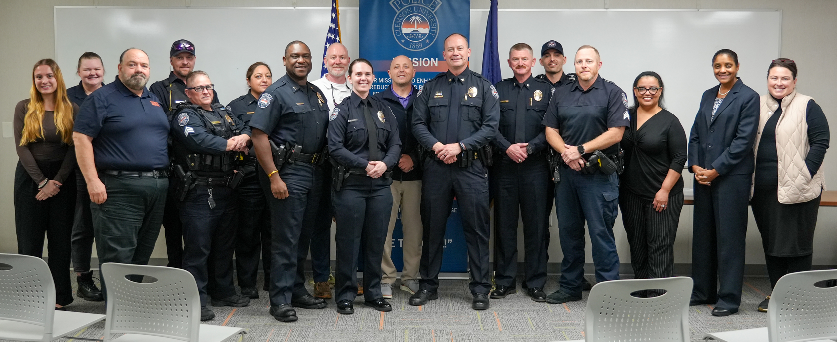 A group of law enforcement officers and other safety personnel pose for a photo.