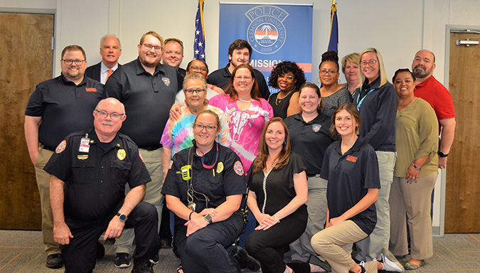 The dispatch team standing in front of the USA and South Carolina state flags. 