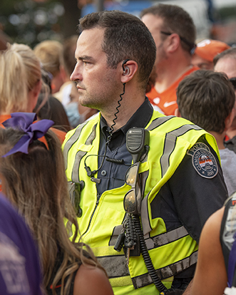Clemson police officer remaining vigilant in a crowd.