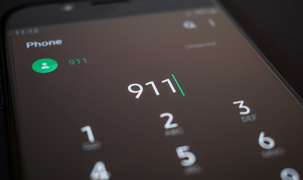 A smartphone showing the phone app open with 911 dialed
