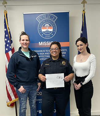 Sgt. Young and two female students.