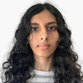 Head-and-shoulders portrait of a person with long, curly dark hair against a plain light background.