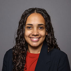 Smiling woman in a dark blazer.