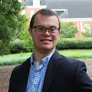 Smiling student in an outdoor garden area.