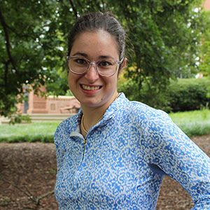 Smiling student in an outdoor garden area.