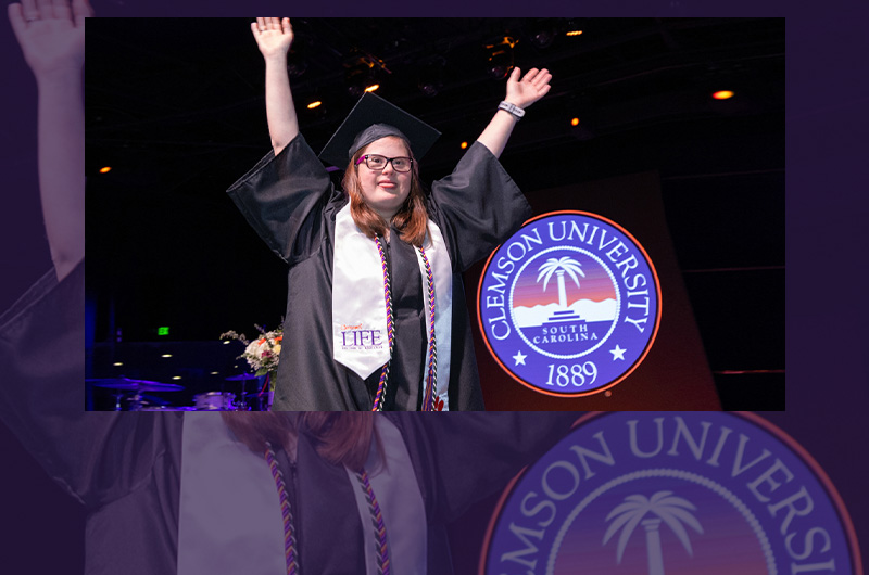 LIFE Graduate raises hands in celebration at graduation