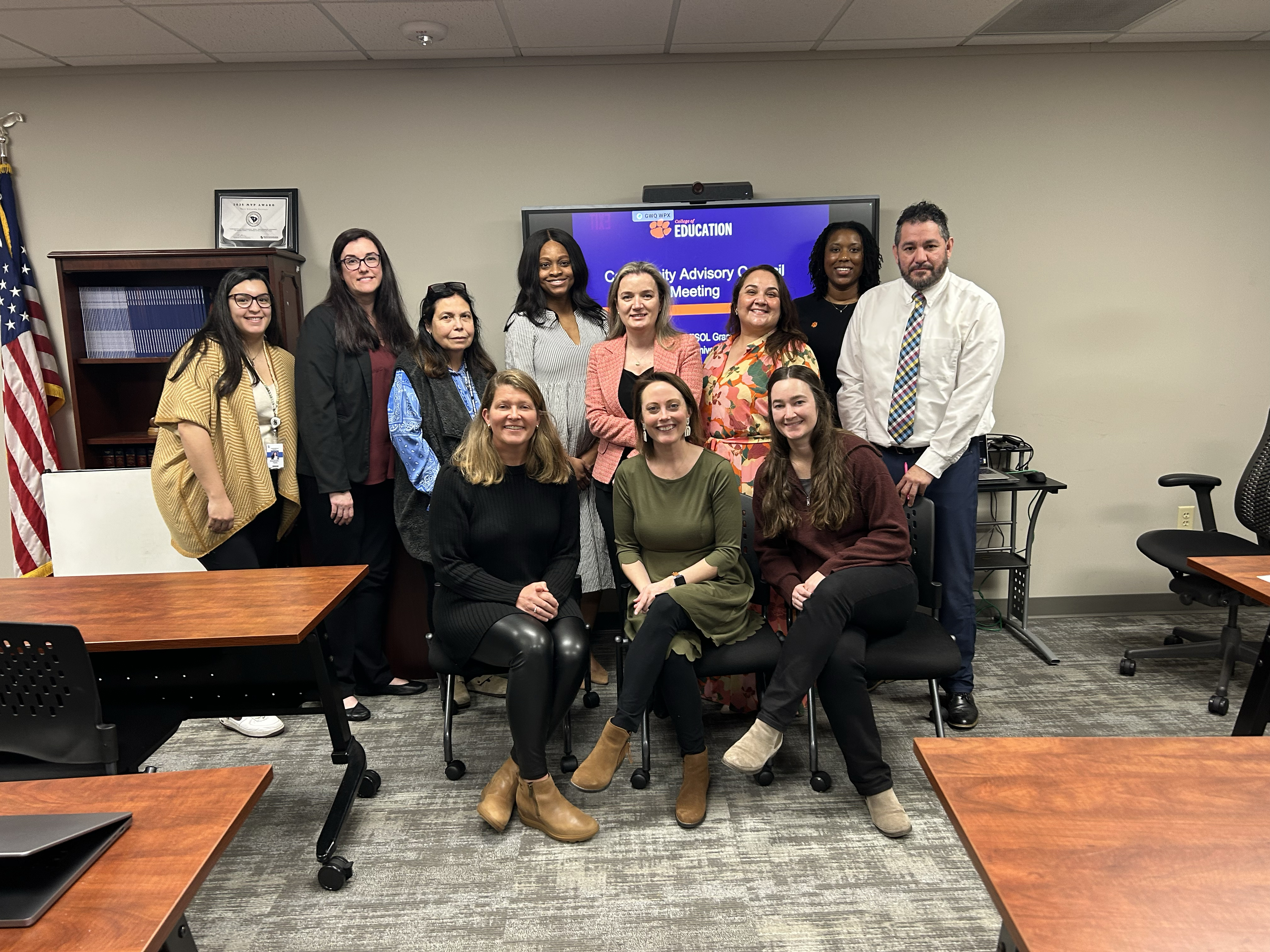 Group photo of education professionals at an advisory meeting.