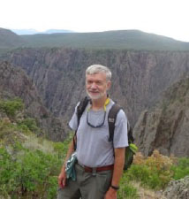 man standing in front of mountains