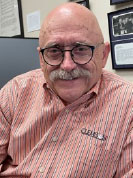 man smiling in his office