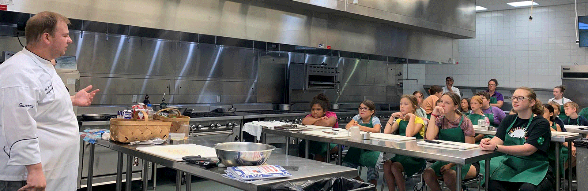Chef with kids in professional kitchen
