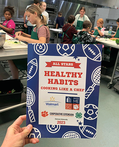 healthy habits flyer in front of kids in the kitchen