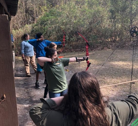 kids taking archery practice