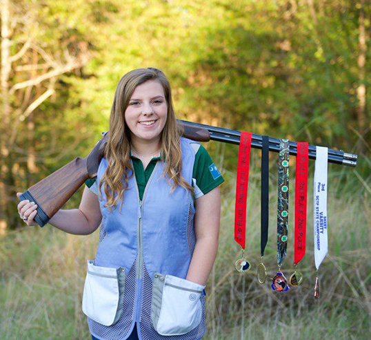 girl with shooting medals