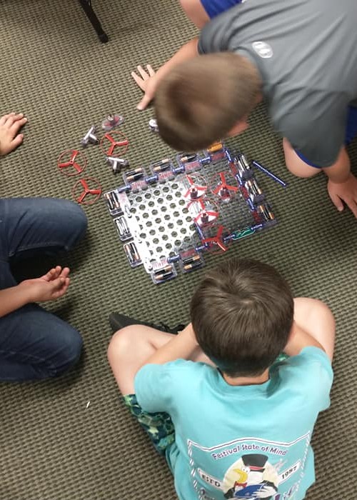 adults helping kids