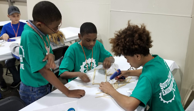 4 h engineering students assembling a prototype