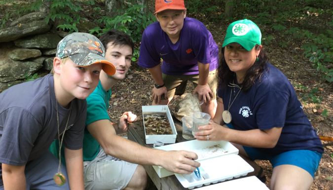 students and patricia whitner taking stream samples