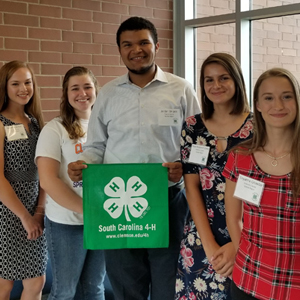 pickney leadership ambassadors holding a 4 h flag