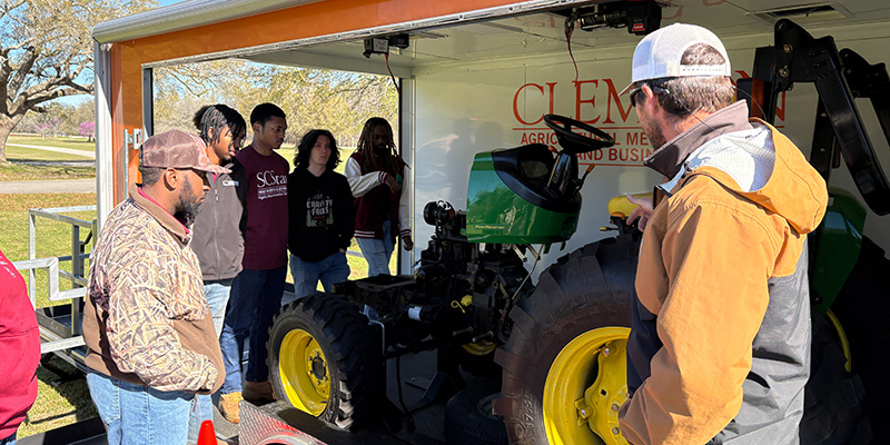 students looking at lawn equipment