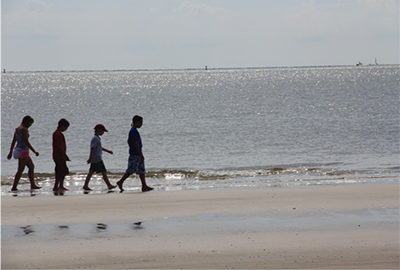kids walking on the beach on a sunny day