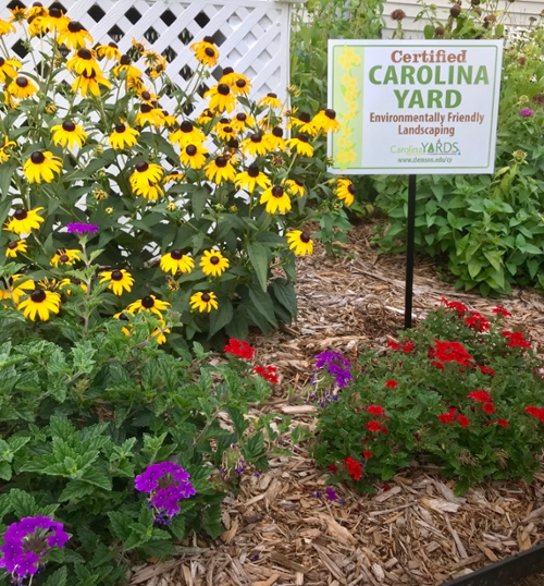 Certified Carolina Yard sign in a garden bed