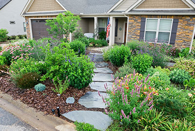 landscaped front yard with stone pathway