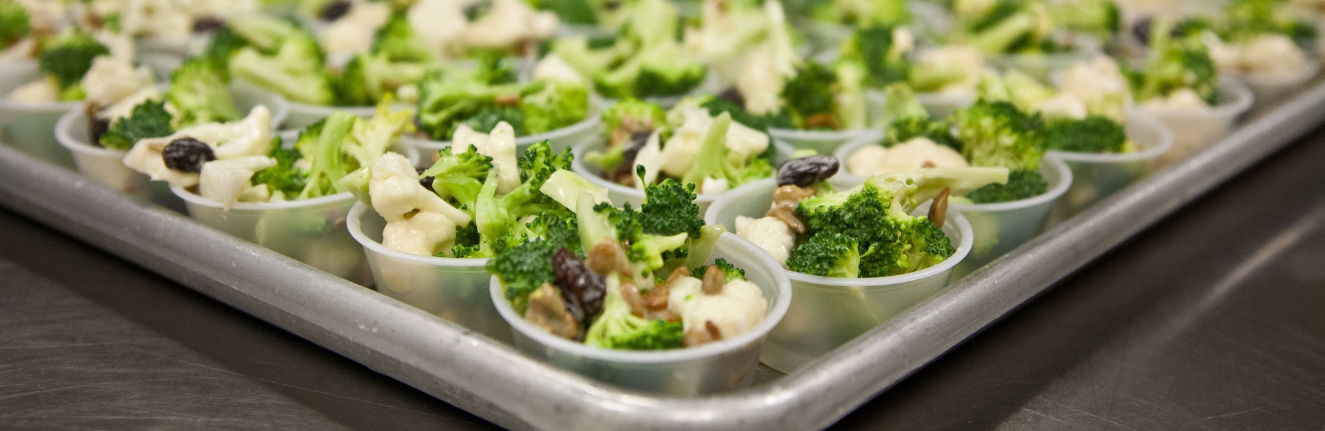 broccoli salad dished into sample size serving cups